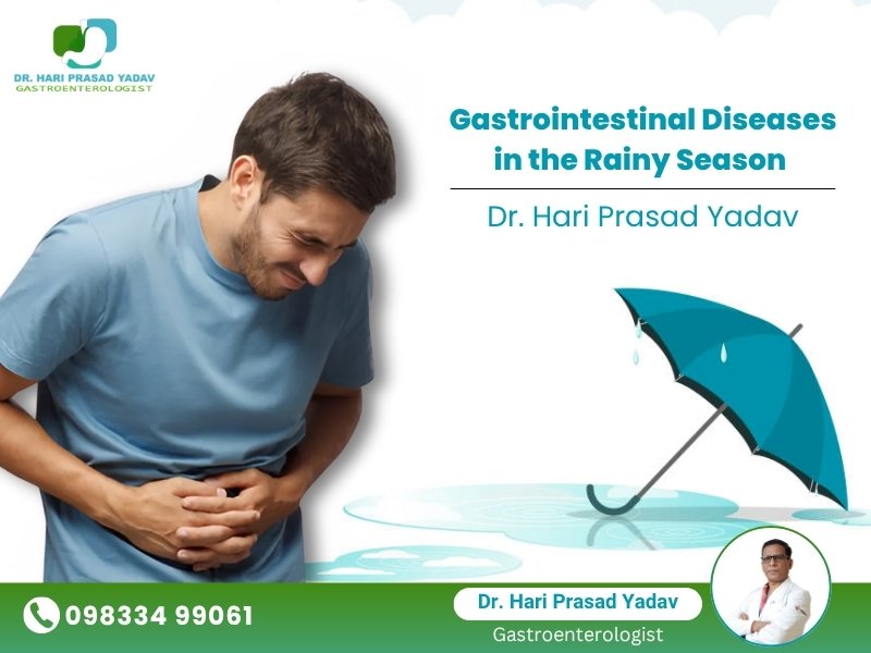 A man holding his stomach in pain, symbolizing gastrointestinal issues during the rainy season, with a blue umbrella and water puddle illustration. Includes Dr. Hari Prasad Yadav’s name, contact number, and photo.